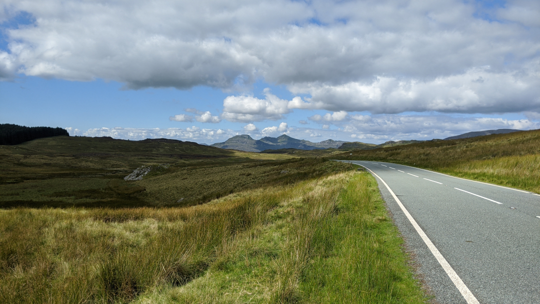 Road in Snowdonia National park, view of Stwlan Dam in the distance